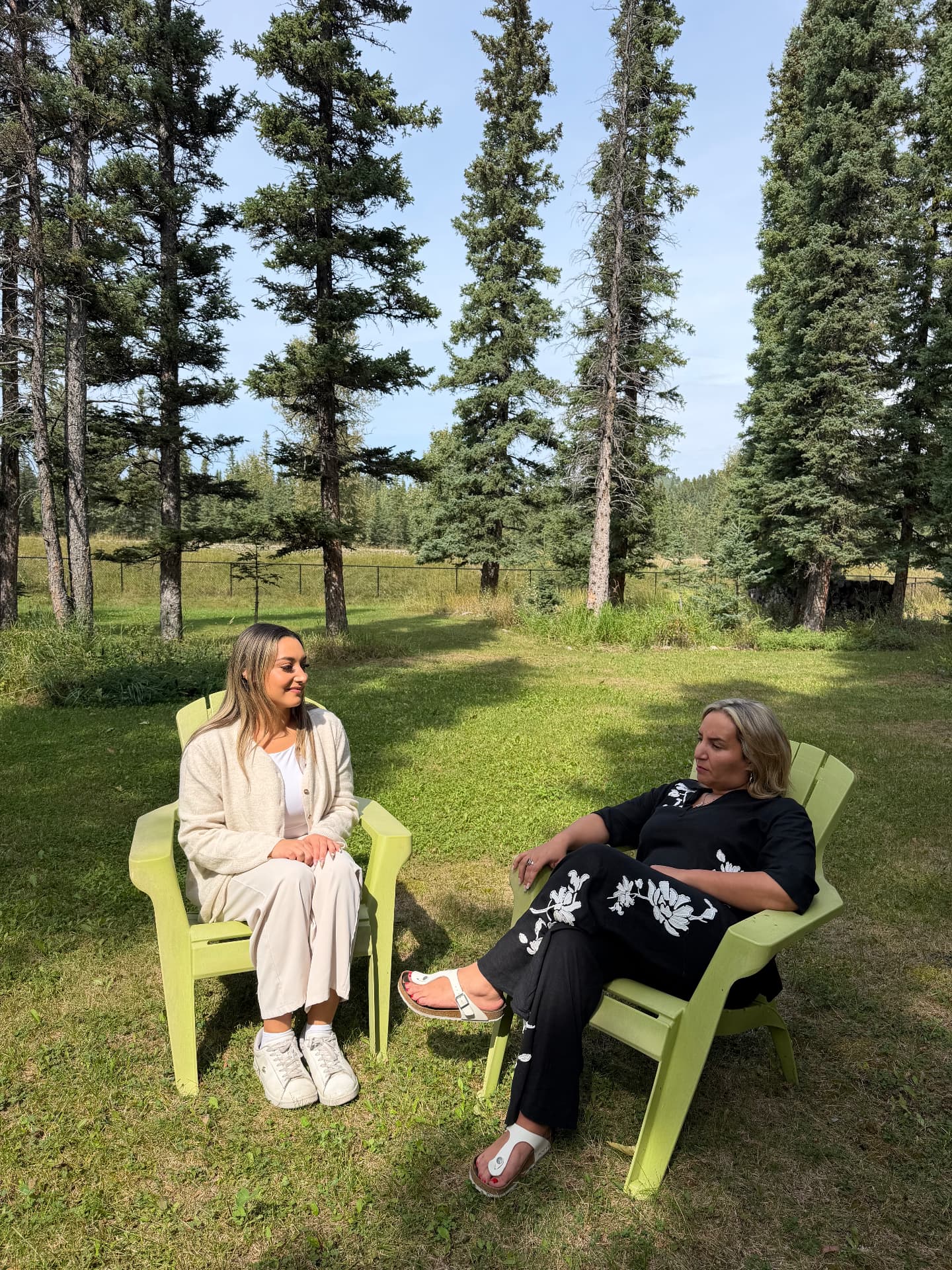 A Vita practitioner and guest in conversation among the trees