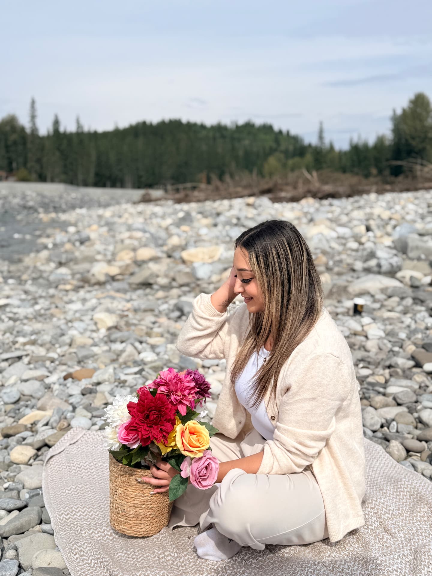 A Vita guest resting beside the river in Bragg Creek, holding flowers